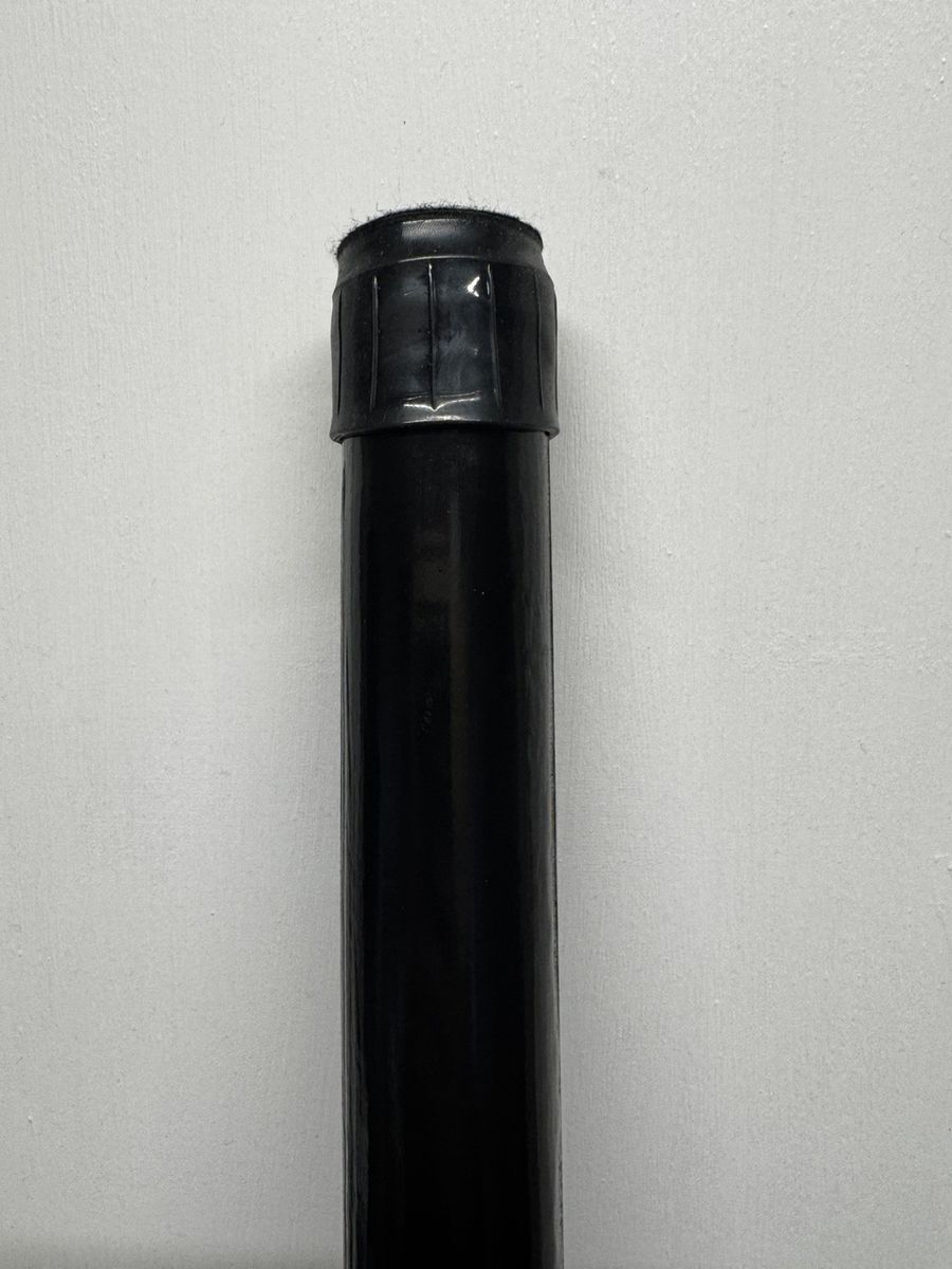A pole in the black finish showing the end cap