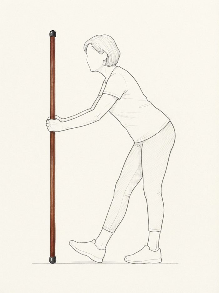 Standing hamstring stretch using the pole for support